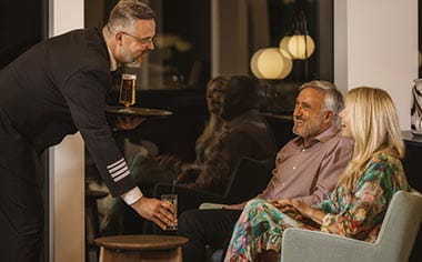 A couple being served drinks int he Lorelei Lounge on the Upper Deck of Spirit of the Rhine A couple being served drinks int he Lorelei Lounge on the Upper Deck of Spirit of the Rhine